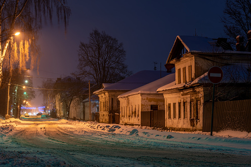 Small old snow-covered street in a small ancient town.