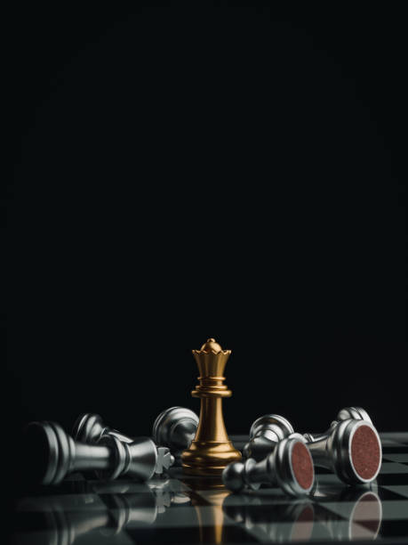 istock The gold queen chess piece standing with falling silver pawn chess pieces on chessboard on dark background with copy space, vertical style. Leadership, winner, competition, business strategy concept. 1359922675