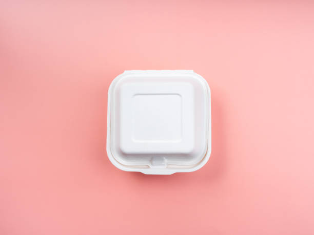 istock Biodegradable and recycle food container for green alternatives and eco-friendly. White square unbleached plant fiber food box isolated on pink background, top view. 1359922690