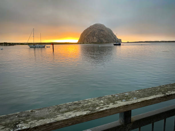 istock Morrow Bay Rock with Boats in Bay 1359923742