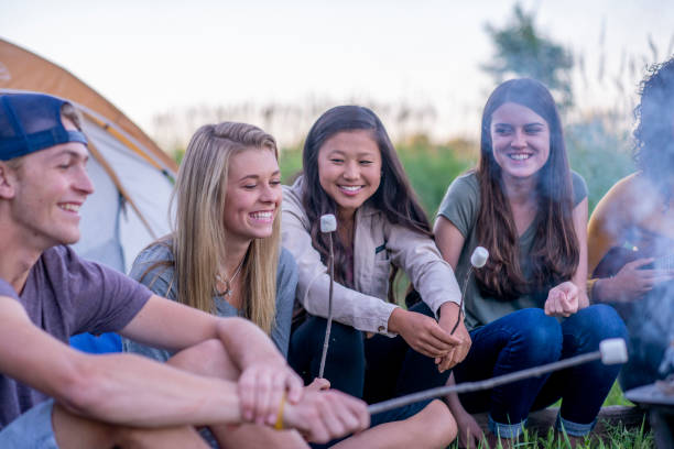 istock Teens Hanging Out Around the Fire 1359925553