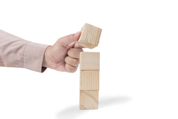istock Hand put the stack of wooden block toy 1359927651