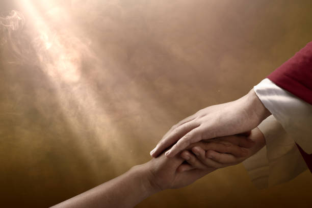 Two unrecognizable caucasian peoples hands are holding each others wrist in front of pure white background. Arms are forming a diagonal line from the right upper corner to the left bottom corner.