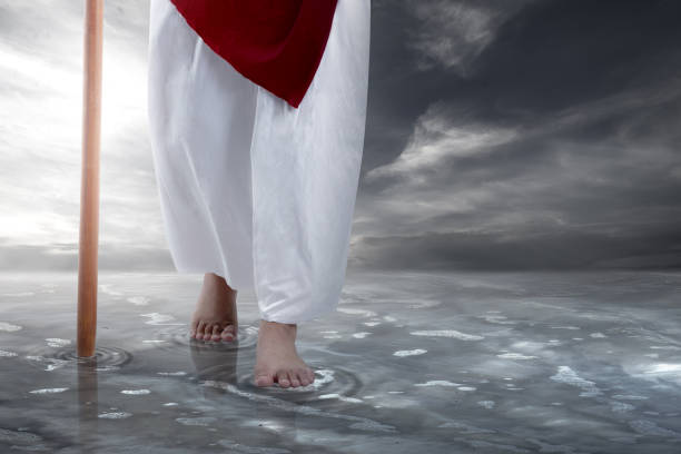 Jesus Christ walking with stick on the water Jesus Christ walking with stick on the water with dramatic background worshipper stock pictures, royalty-free photos & images