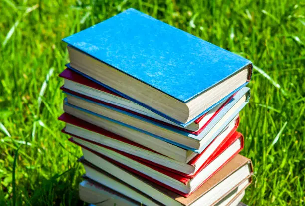 Books with a Blank Cover on the Fresh Grass closeup