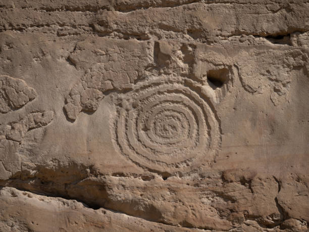 Chaco Culture National Historic Park Spiral or Circular Petroglyph Ancient engraving or petroglyph on a sandstone cliff at Chaco Culture National Historic Park in New Mexico. chaco culture national historic park stock pictures, royalty-free photos & images