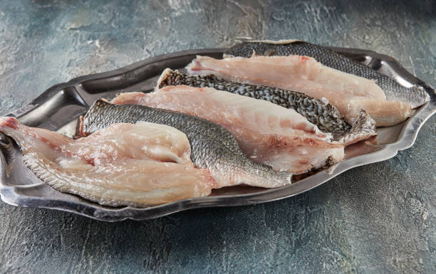 istock Fresh bass fish, ready to cook on tray 1359935164