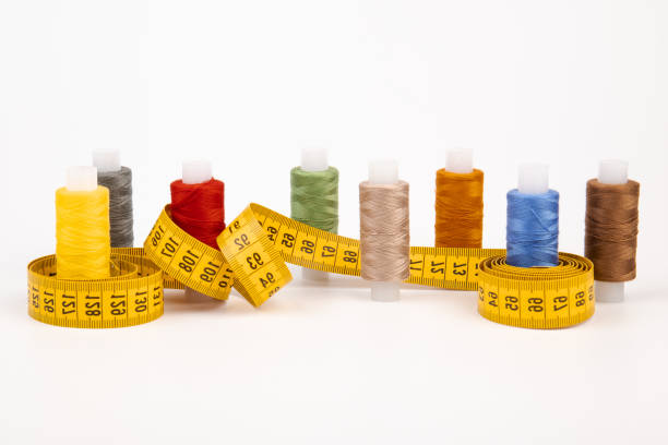 istock Sewing threads, sewing centimeter or measuring tape, isolated on white background. 1359936108
