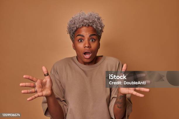 Curious Young African Female With Hand Near Ear Trying To Overhear Something Stock Photo - Download Image Now