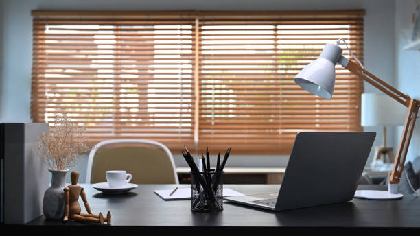 istock Comfortable workplace with laptop computer and supplies in home office interior. 1359942078