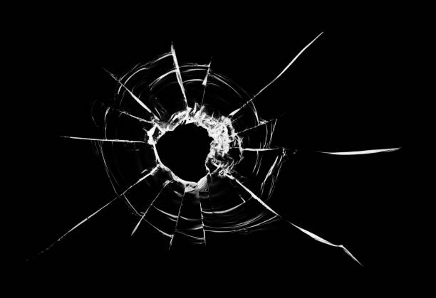 istock Bullet hole in the glass. Isolated on a black background. 1359942654