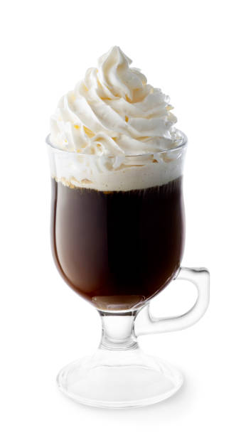 irish coffee with whipped cream in glass cup isolated stock photo