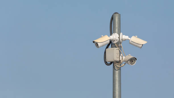 istock Swivel high quality CCTV camera on sky background. 1359943427