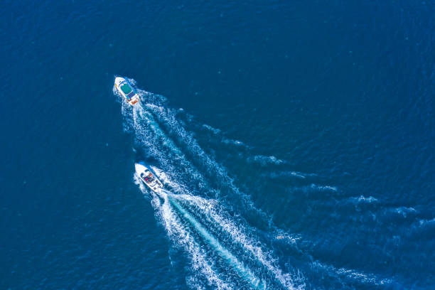 istock Two boats floating on the sea at high speed drone view. 1359945877