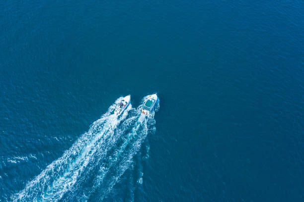 istock Two boats floating on the sea at high speed drone view. 1359945908