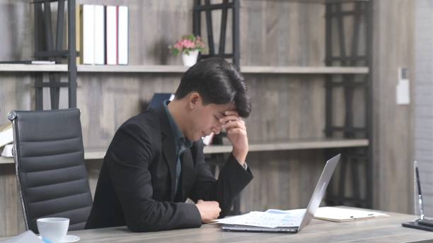 istock Asian businessman with frustrated and depressed expression while working office desk, office lifestyle 1359947279