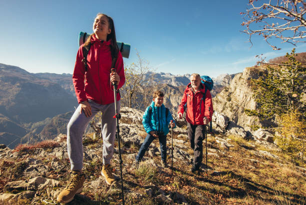 istock Father with two kids hiking in mountains 1359948923