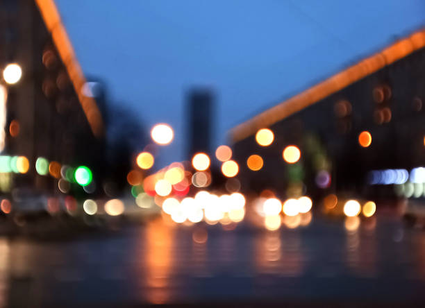 istock Abstract blurred defocused night city background with traffic lights bokeh 1359950874