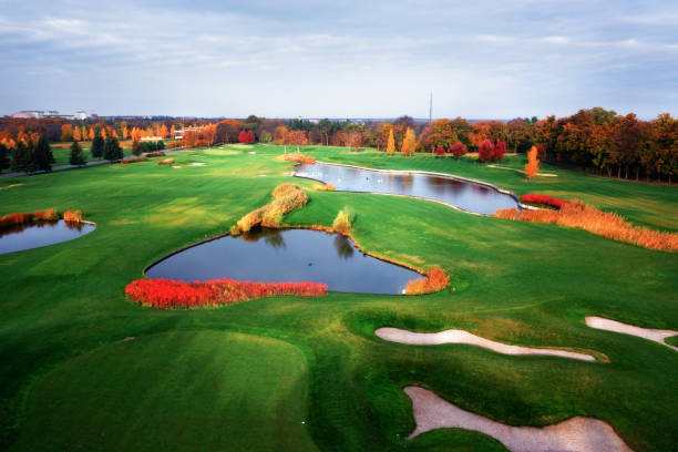 Large green golf course with clear lakes and high quality lawn drone view.