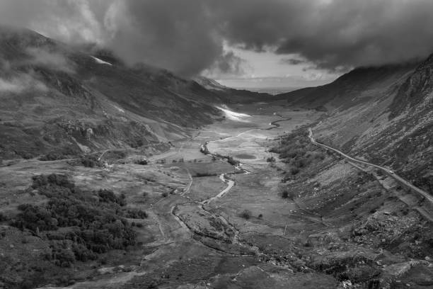 Black and white Aerial view of flying drone Epic landscape image in Autumn looking down Nant Fracon valley from Llyn Idwal with moody sky and copyspace Black and white Aerial view of flying drone Stunning epic landscape image in Autumn looking down Nant Fracon valley from Llyn Idwal dramatic sky and copy space snowdonia national park photos stock pictures, royalty-free photos & images