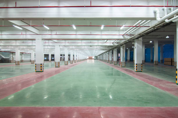 istock perspective of empty space in factory warehouse 1359956710