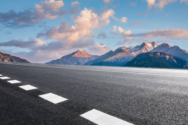 istock Asphalt road and mountain scenery at sunrise 1359957595