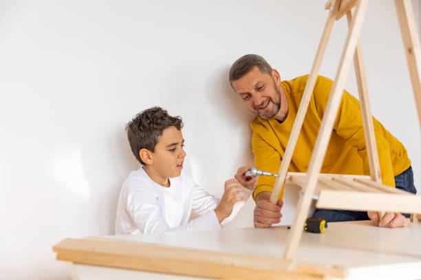 istock Father and son assembling made furniture 1359961951