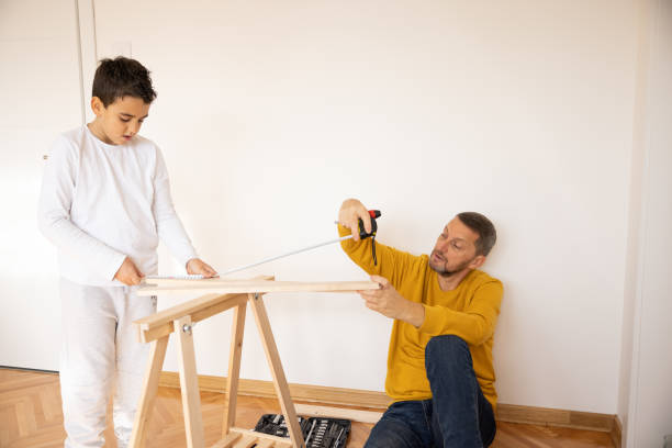 istock Father and son assembling made furniture 1359963024