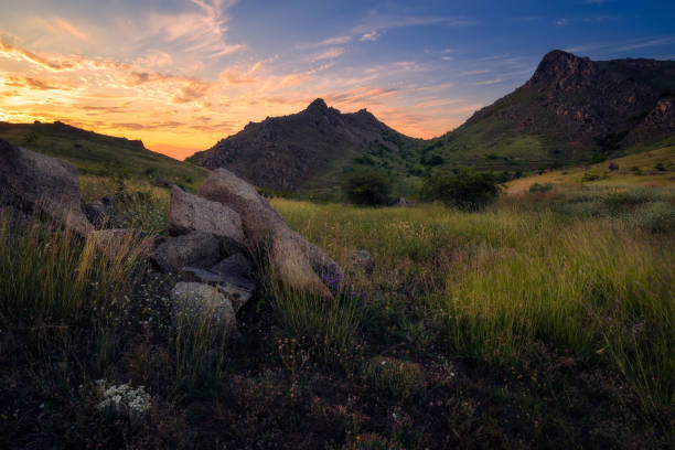 Sunset scene in Macin mountains with some rocks in the foreground stock photo