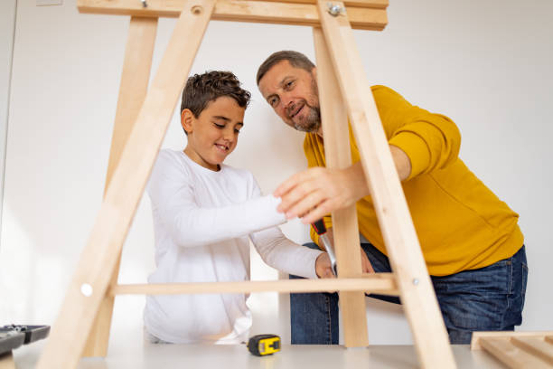 istock Father and son assembling made furniture 1359963934