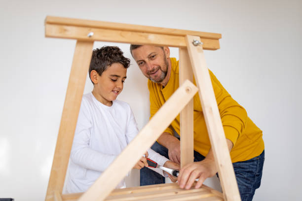 istock Father and son assembling made furniture 1359964100