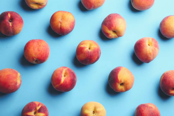 istock Fresh ripe peaches on light blue background, flat lay 1359964249