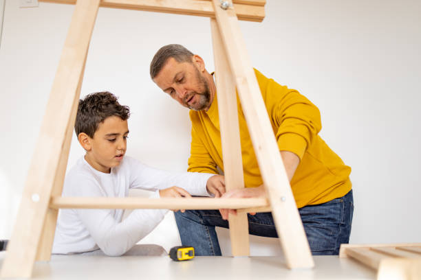 istock Father and son assembling made furniture 1359964371