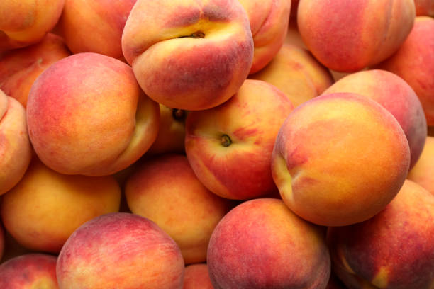 istock Fresh ripe peaches as background, top view 1359964459