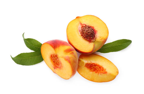istock Cut fresh ripe peaches with leaves on white background, top view 1359964461