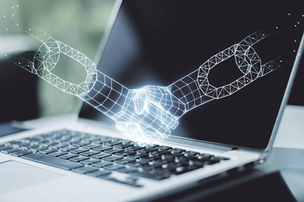 istock Creative concept of blockchain technology with handshake on modern laptop background. digital money transfers and decentralization concept. Multiexposure 1359965255