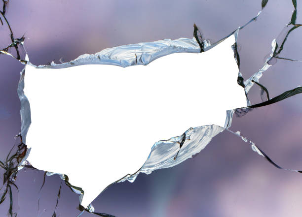 istock Cracks in the window glass on a background of sky. 1359965492