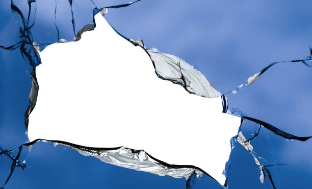 istock Cracks in the window glass on a background of sky. 1359965497