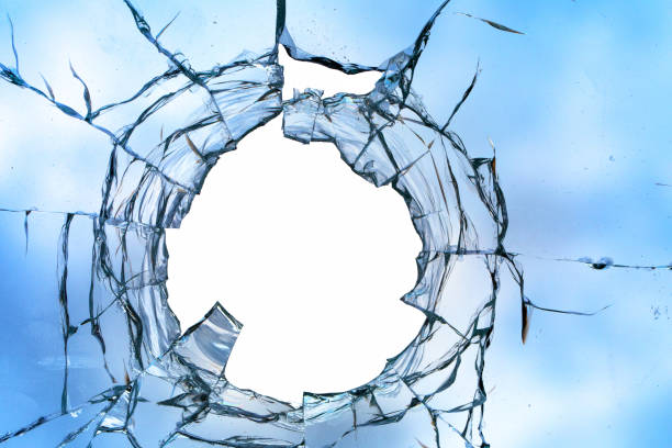 istock Cracks in the window glass on a background of sky. 1359965503
