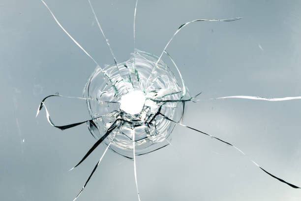 istock Cracks in the window glass on a background of sky. 1359965510