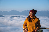 istock Portrait of a young female traveler with a beautiful mountain and sea of fog in the morning 1359965690