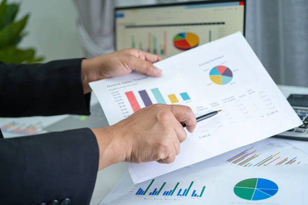 istock Asian accountant working and analyzing financial reports project accounting with chart graph and calculator in modern office, finance and business concept. 1359966050