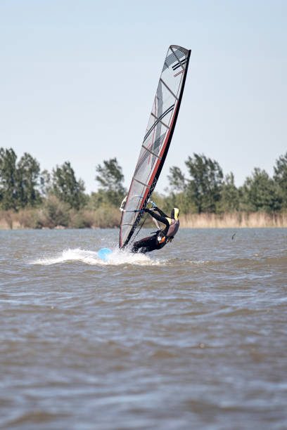 istock Windsurfer surfing on a windy summertime day at the river. 1359967151