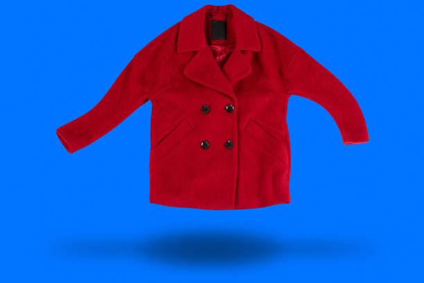 istock red coat levitates on blue background casting shadow, fashion concept 1359968424