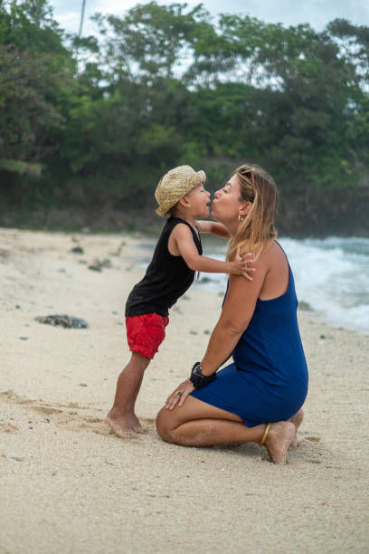 istock Mother bonding with her son on the beach 1359970411