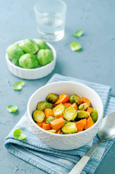 istock Roasted Sweet potato and Brussels Sprouts on a background 1359970466
