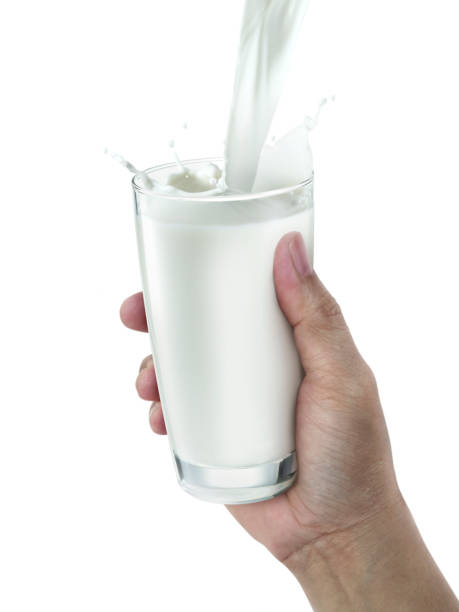istock hand with glass of milk on a white background 1359972063