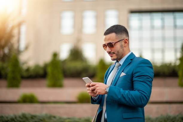 istock Businessman holding smart phone 1359972263