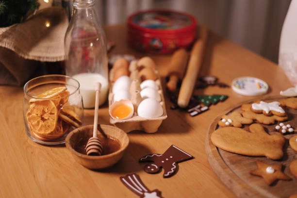 istock Home bakery, cooking traditional festive sweets. Preparing for making gingerbread dough on wooden table. New Year celebration traditions. Honey and dried orange wedges. Christmas mood 1359975030