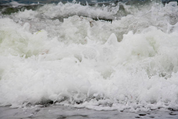 Sea views directly from the beach, sea waves and sandy shore. Coast of the Crimean Peninsula. Travel concept.